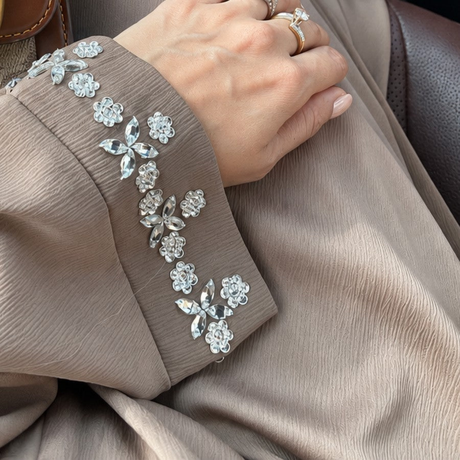 Hand-set stonework on the sleeve of the Opal abaya